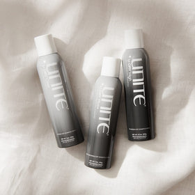 UNITE U:DRY High held in hand to show 6.7 oz size and travel convenience