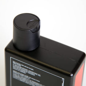 UPPERCUT DELUXE bottle beside ruler for scale, illustrates 8oz travel-friendly size