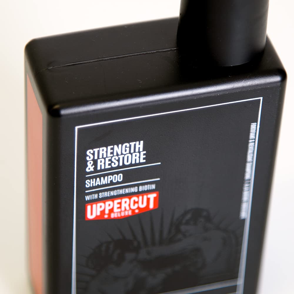 UPPERCUT DELUXE label close-up highlighting biotin and caffeine, clarifies key actives