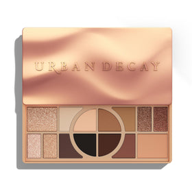Urban Decay palette open showing 14 warm shades for versatile looks