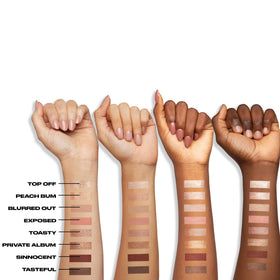 Urban Decay stick held in hand to show compact travel-friendly size