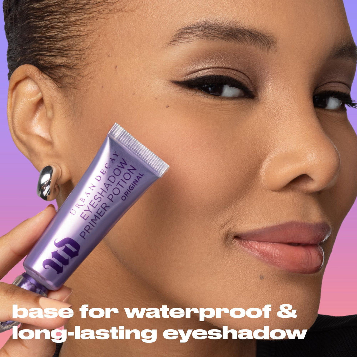 Urban Decay primer next to eyeshadow palette, improves pigment intensity