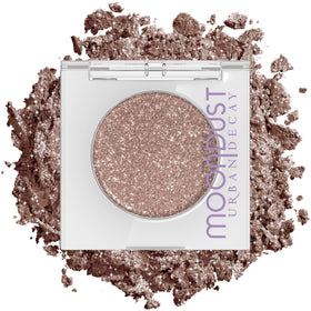 Urban Decay Space Cowboy single-pan showing champagne-silver sparkle benefit: intense reflective finish