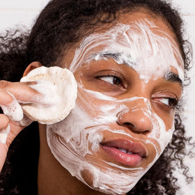 Urban Skin Rx cleansing bar held in hand to show size and portability for travel-friendly use