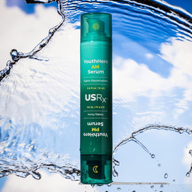 Urban Skin Rx travel-size bottle held in hand showing compact portability benefit