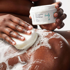 Urban Skin Rx bar held in hand to show 5 oz size and travel-friendly scale