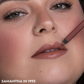 URBAN DECAY pencil in hand demonstrates size and one-handed application