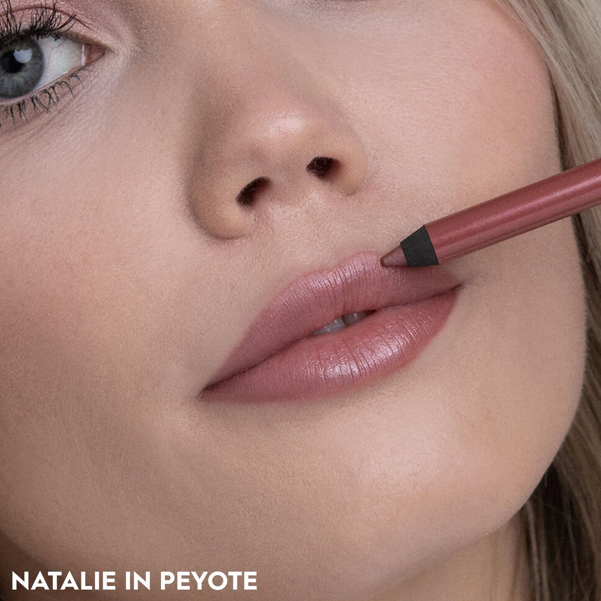 URBAN DECAY model applying Peyote lip pencil for longwear definition