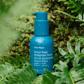 Ursa Major serum being applied to fingers demonstrating layering under moisturizer benefit