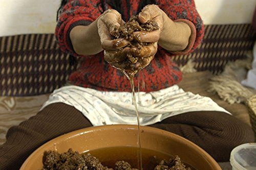 US Organic bottle beside argan fruit and leaves showing single-ingredient sourcing benefit