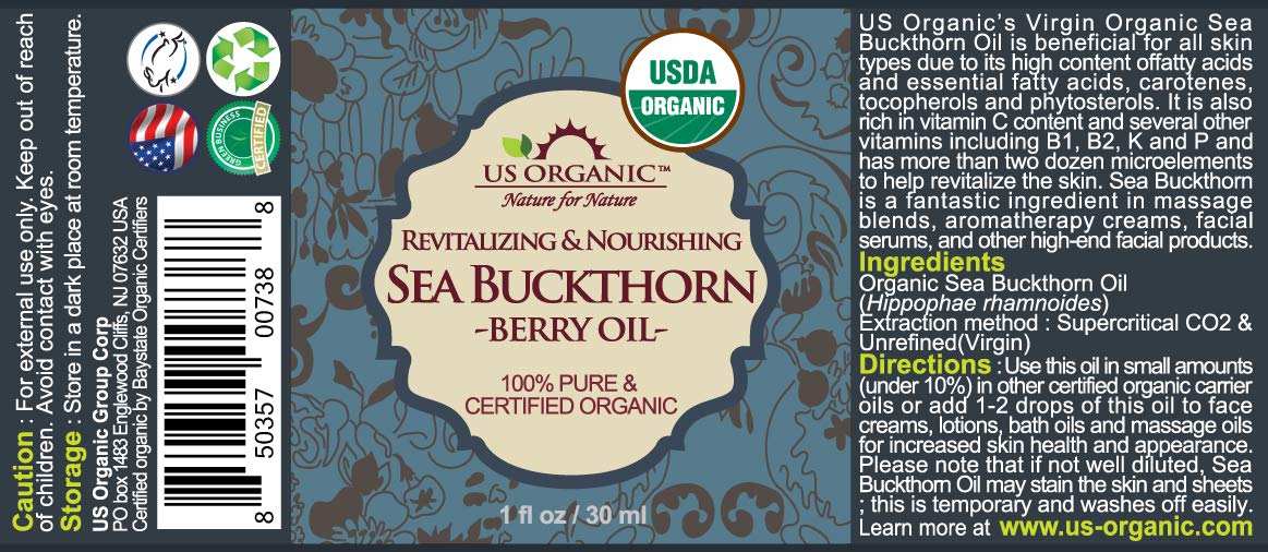 US Organic golden-orange oil drops showing smooth texture and nutrient-rich color