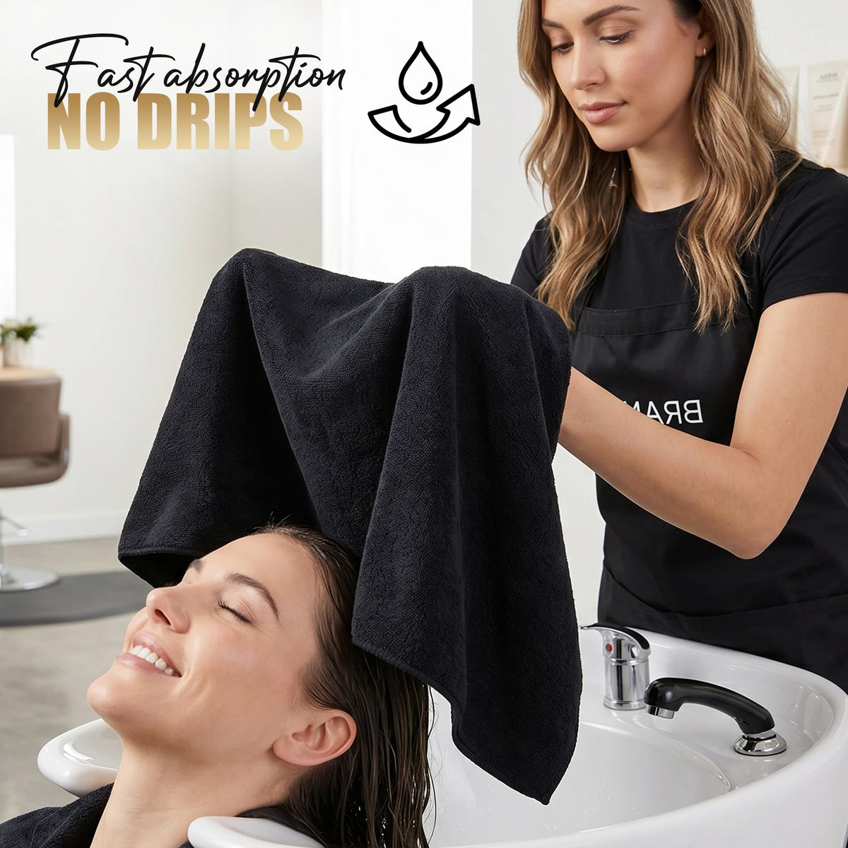 Utopia Towels beside a hand to show 16x27-inch useful size