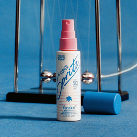 VACATION bottle inside travel pouch conveying TSA-compliant portability and daily readiness
