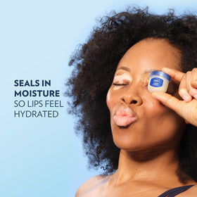 Vaseline application on lips delivering instant softening and gloss