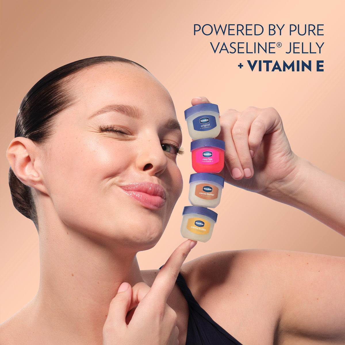 Vaseline bottles arranged with cocoa beans styled scene conveying warm scent benefit