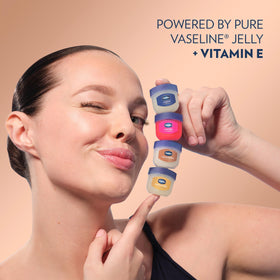 Vaseline bottles arranged with cocoa beans styled scene conveying warm scent benefit