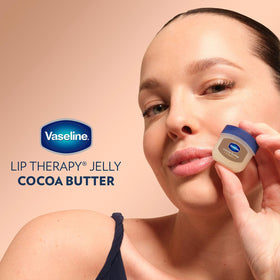 Vaseline jar beside cocoa beans conveying cocoa butter nourishment