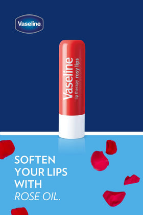 Hand holding Vaseline Lip Rosy stick demonstrating portable hydration