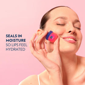 Hand holding Vaseline mini jar to show portable size and convenient use