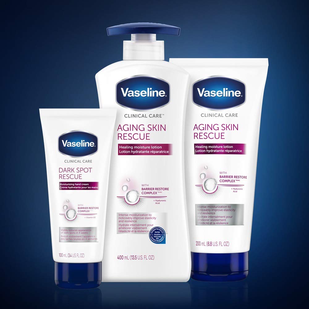 Vaseline bottle next to hand showing 13.5 fl oz size