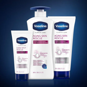 Vaseline bottle next to hand showing 13.5 fl oz size