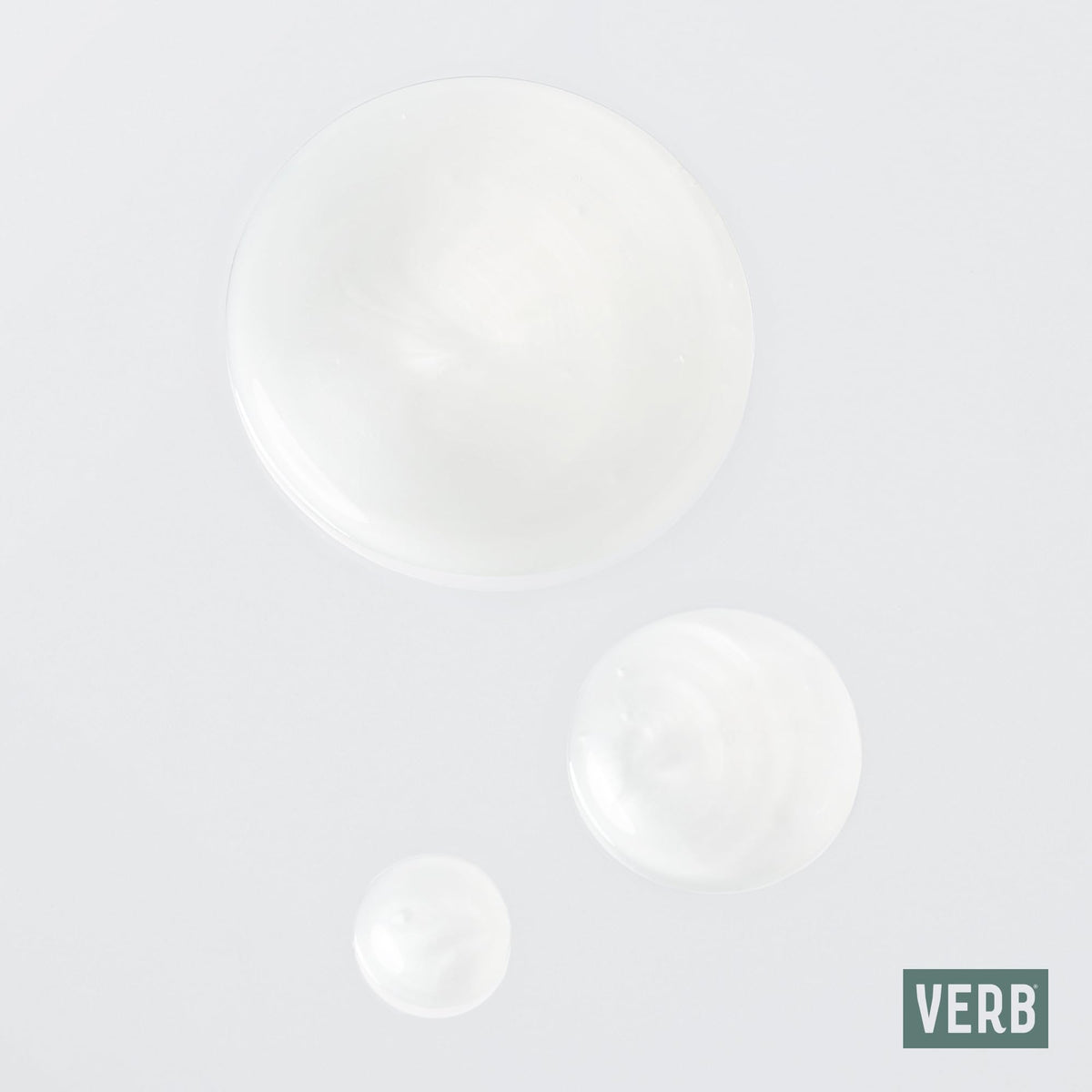 VERB Ghost duo held in hand to demonstrate 12 fl oz bottle scale