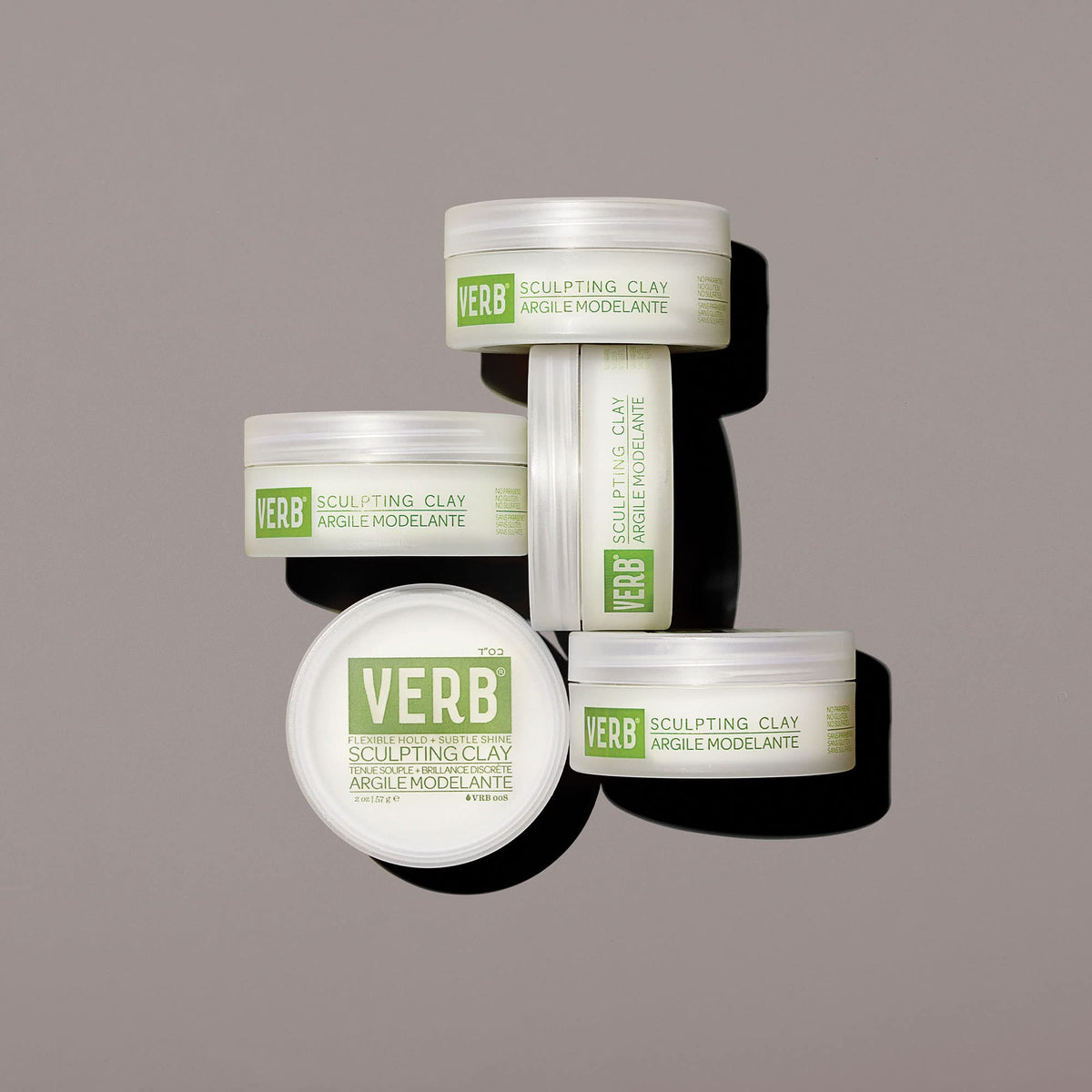 VERB sculpting clay next to everyday items to show 2 oz size and portability