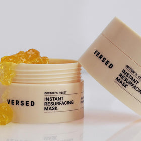 Versed tube next to hand to show 1.7 fl oz size and portability