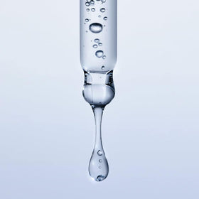 Versed Moisture Maker 1oz bottle next to common object showing compact travel-friendly size