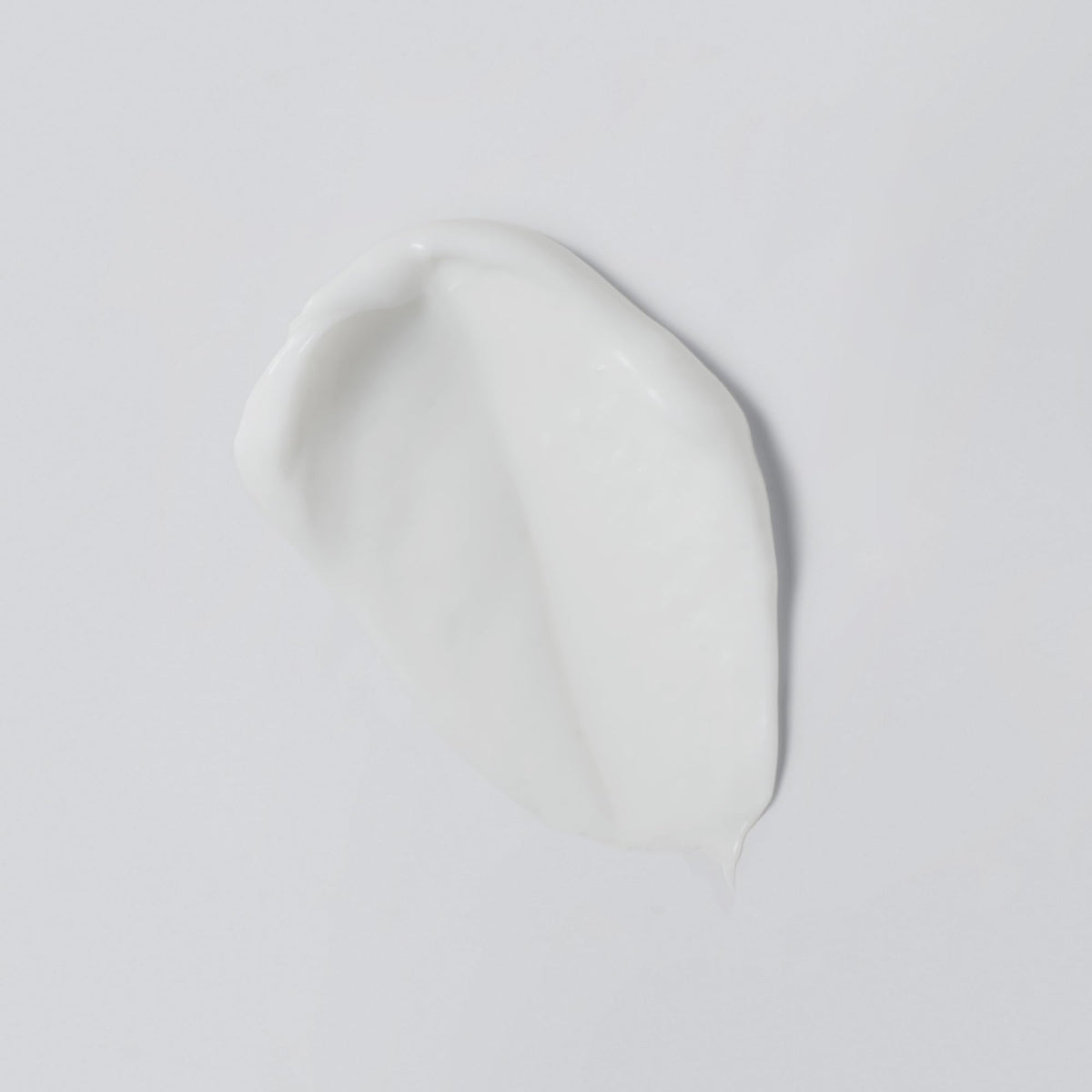 Versed cream texture close-up illustrating lightweight, cushiony finish