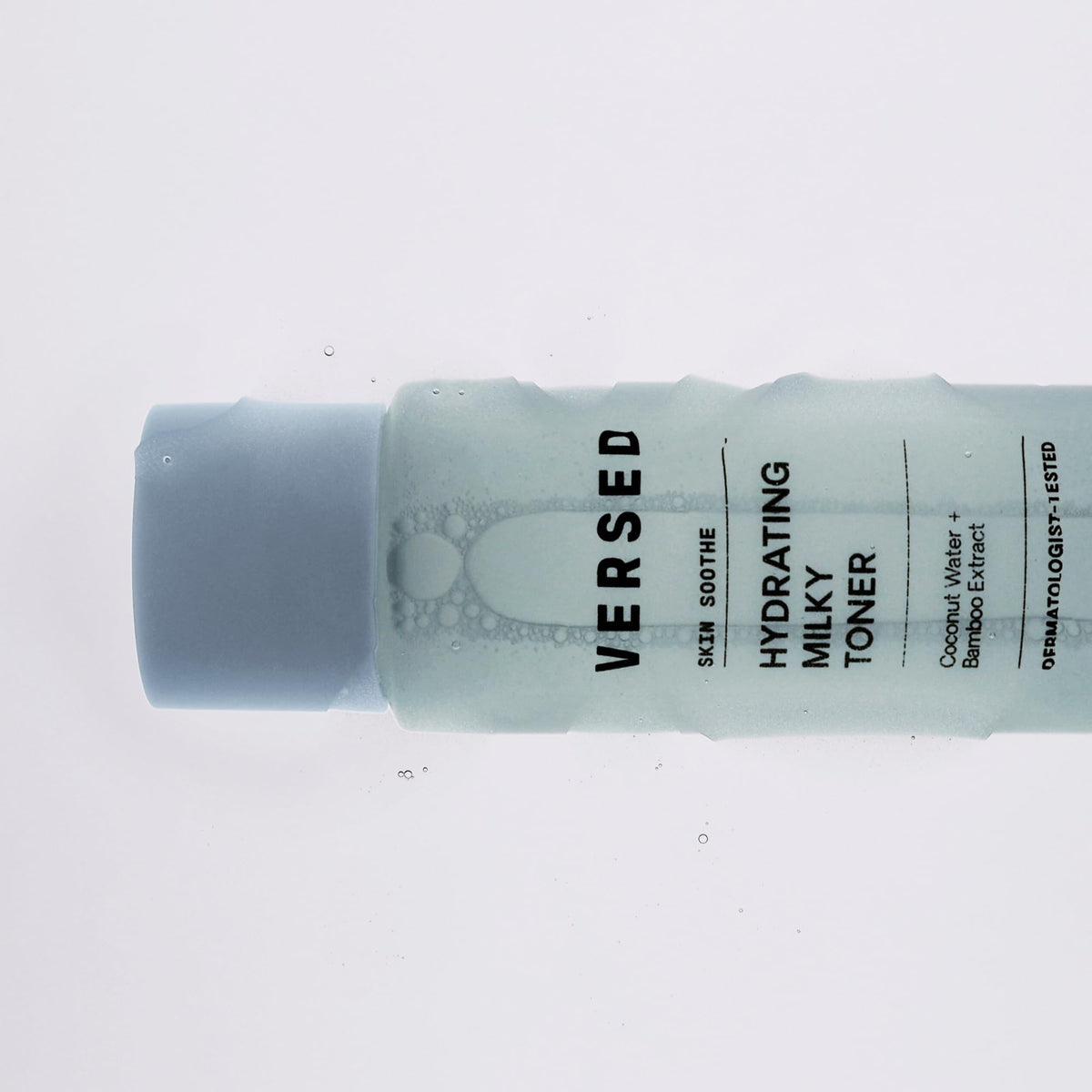 Versed toner in hand being applied to skin for quick-absorbing hydration