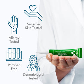 Vichy size comparison in hand showing tube scale for travel-friendly convenience