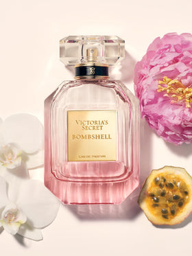 Victoria's Secret Bombshell shimmer mist spraying on wrist to refresh scent quickly