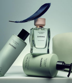 Victoria's Secret applying lotion on forearm illustrating hydration and scent layering