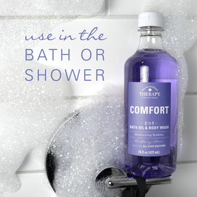 Village Naturals Therapy bottle placed by bathtub for relaxing at-home spa benefit