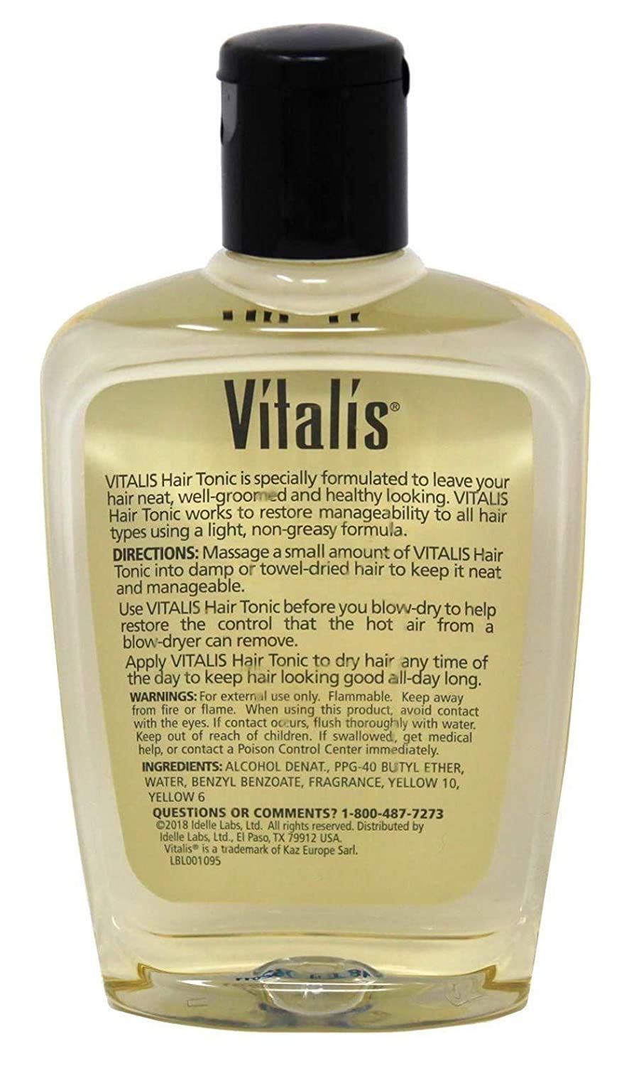 Hand applying Vitalis hair tonic to strands demonstrating even distribution and improved manageability