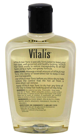 Hand applying Vitalis hair tonic to strands demonstrating even distribution and improved manageability