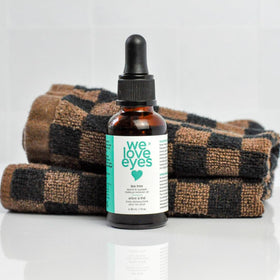 We Love Eyes label closeup highlighting tea tree and clean ingredients benefit