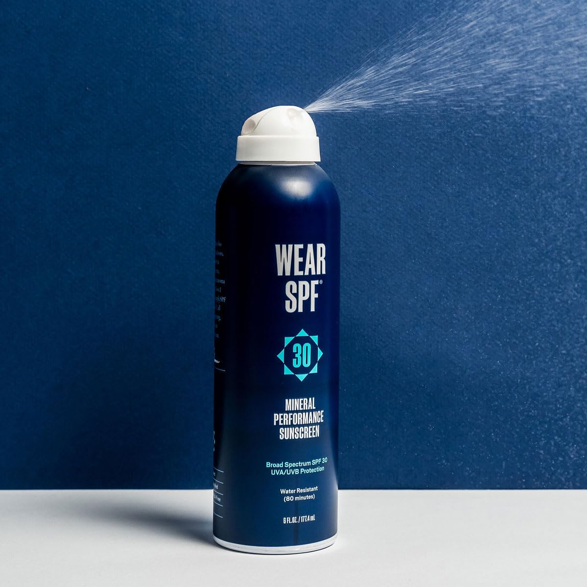 WearSPF sunscreen spray in use at beach showing water-resistant protection during activity