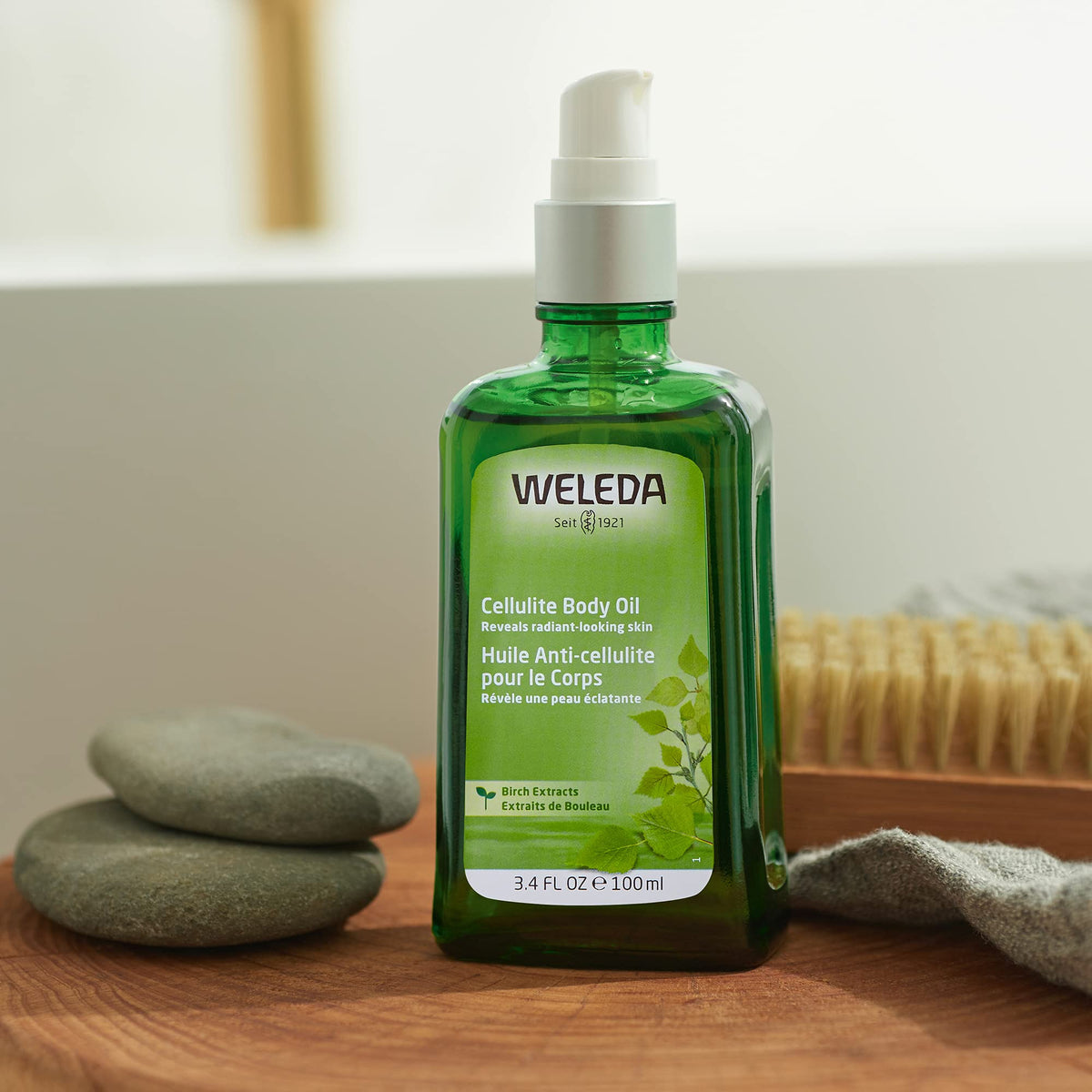 Weleda oil being poured to show lightweight texture and quick absorption benefit