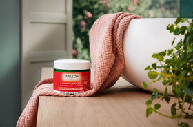 Weleda body butter being applied to forearm demonstrating quick absorption benefit