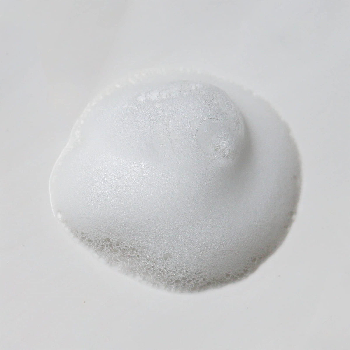 Weleda gentle cleansing foam bottle on bathroom counter suggests daily skincare routine