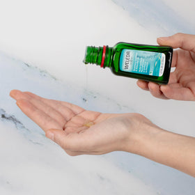 Weleda bottle staged on bathroom shelf, suggests easy everyday use