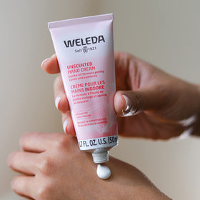 Weleda hand cream being applied to hands demonstrating smooth non-greasy finish