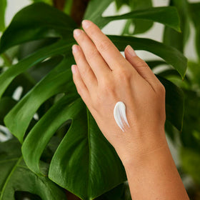 Weleda tube next to smartphone showing 1.7 fl oz size for easy portability