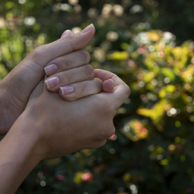 Weleda cream being applied to hands illustrating smooth, non-greasy finish