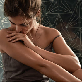Weleda wild rose applied to forearm demonstrating hydration and radiant finish