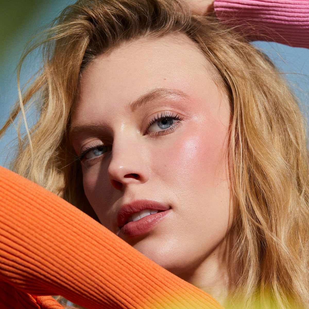 Well People balm applied on lips showing sheer peach tint and natural look benefit