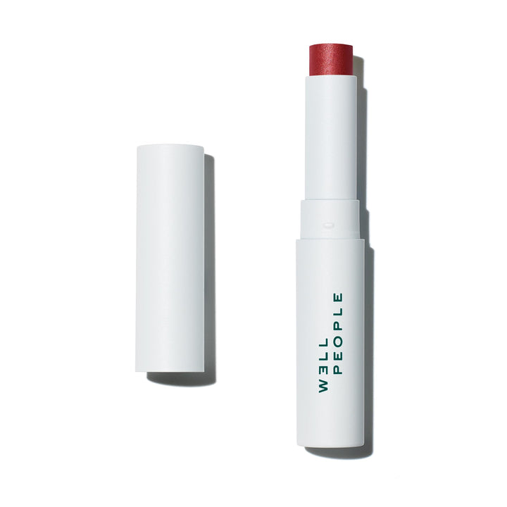 Well People lip butter front view showing twist-up tube and compact design for travel