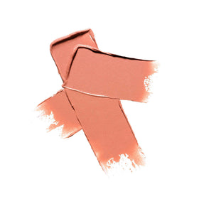 Well People blush stick beside a hand for scale showing compact size benefit